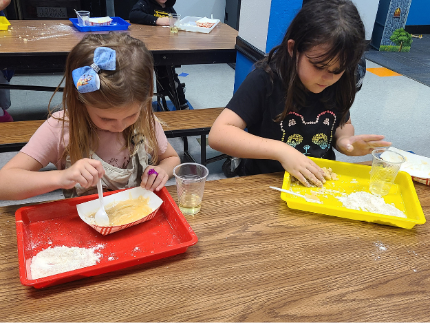 Kids make moon sand two kids mix materials together to make moon sand at the Blaine Clubhouse