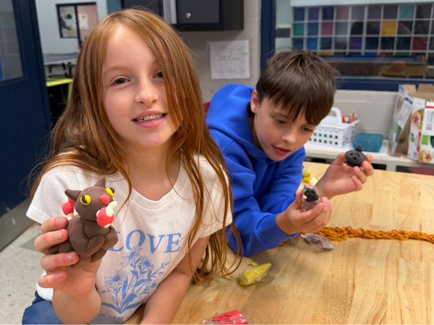 kids with clay creatures